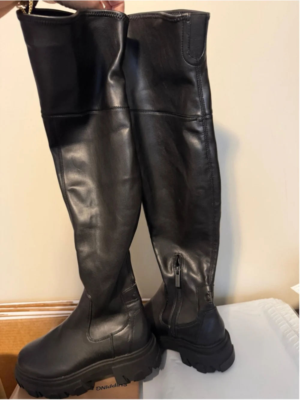 Calvin Klein black chunky platform boots featuring a thick, ridged lug sole.